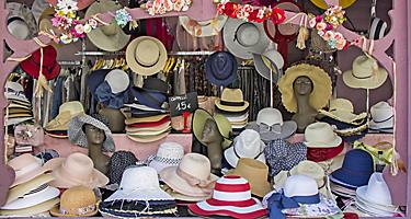 Open market stall with summer straw hats in Trieste, Italy