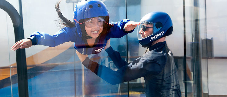 Girl with instructor, floating in the Ripcord by iFly
