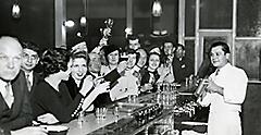 black and white photo of customers at a Philadelphia speakeasy bar. North America.